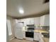 Modern kitchen with white cabinetry, updated appliances, and a stylish backsplash for a clean look at 3007 Wainwright Ct, New Port Richey, FL 34655