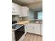 Well-lit kitchen with modern appliances, butcher block countertops, and a view into the living area at 3007 Wainwright Ct, New Port Richey, FL 34655