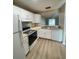 Bright, updated kitchen featuring white cabinets, stainless steel appliances, and butcher block countertops at 3007 Wainwright Ct, New Port Richey, FL 34655