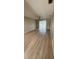 Spacious living room with wood-look flooring and a sliding glass door at 3007 Wainwright Ct, New Port Richey, FL 34655