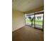 A cozy outdoor patio with view of green lawn and tropical landscaping at 3007 Wainwright Ct, New Port Richey, FL 34655