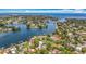 An aerial view of the neighborhood, showcasing the waterfront property and surrounding mature greenery at 301 23Rd Ne Ave, St Petersburg, FL 33704