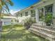 A backyard offering an outdoor living space, with a pool, mature greenery and a house with a modern exterior at 301 23Rd Ne Ave, St Petersburg, FL 33704