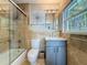 Bathroom featuring stone tile, glass shower doors, and a vanity with marble countertops at 301 23Rd Ne Ave, St Petersburg, FL 33704
