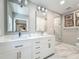 Modern bathroom with double vanity, marble floors, and glass enclosed shower at 301 23Rd Ne Ave, St Petersburg, FL 33704