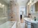 Stylish bathroom showcasing a bathtub with shower, sink, and decorative mirror, exuding charm and comfort at 301 23Rd Ne Ave, St Petersburg, FL 33704