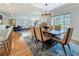 Elegant dining area with a modern chandelier, hardwood floors, and ample seating for guests at 301 23Rd Ne Ave, St Petersburg, FL 33704