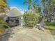 A spacious driveway, lined with greenery, with a modern SUV in front of the property at 301 23Rd Ne Ave, St Petersburg, FL 33704