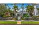 Charming single-story home with lush landscaping, palm trees, and walkway to front door at 301 23Rd Ne Ave, St Petersburg, FL 33704