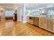Open concept kitchen features stainless steel appliances, wood floors, and views into the living area at 301 23Rd Ne Ave, St Petersburg, FL 33704