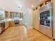 Well-appointed kitchen boasts stainless steel appliances, light wood cabinets, and hardwood floors at 301 23Rd Ne Ave, St Petersburg, FL 33704