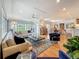 Open-concept living space with hardwood floors, comfortable seating, and adjacent dining area at 301 23Rd Ne Ave, St Petersburg, FL 33704