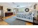 Cozy main bedroom featuring hardwood floors, ceiling fan and large window, providing a comfortable living space at 301 23Rd Ne Ave, St Petersburg, FL 33704