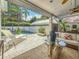 Relaxing outdoor patio with stylish furniture and a lovely view of the beautiful pool and surrounding tropical foliage at 301 23Rd Ne Ave, St Petersburg, FL 33704