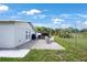 Cozy backyard brick patio with outdoor brick fireplace, and a view of the fenced yard at 3301 Tuckahoe Pl, Holiday, FL 34690