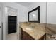 Bathroom features a vanity with a granite countertop and decorative tile backsplash at 3301 Tuckahoe Pl, Holiday, FL 34690