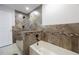 Beautiful bathroom featuring a tub with stylish brown tile accents and shower at 3301 Tuckahoe Pl, Holiday, FL 34690