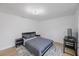 Bedroom with hard wood floors, gray bedding and modern furniture at 3301 Tuckahoe Pl, Holiday, FL 34690