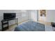 Bright bedroom featuring hardwood floors with an attached bathroom and kitchen view at 3301 Tuckahoe Pl, Holiday, FL 34690