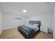 Cozy bedroom with hardwood floors, white walls, and a window offering natural light at 3301 Tuckahoe Pl, Holiday, FL 34690
