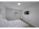 Cozy bedroom with a bed, flat-screen TV, and a large window at 3301 Tuckahoe Pl, Holiday, FL 34690