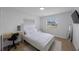 Bright bedroom with white furniture, a desk, and a window at 3301 Tuckahoe Pl, Holiday, FL 34690