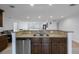 Kitchen island with granite countertop, stainless steel sink, and stylish cabinetry at 3301 Tuckahoe Pl, Holiday, FL 34690