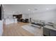 Open-concept living area featuring hardwood floors, a dining area, and modern kitchen, ideal for entertaining and Gathering gatherings at 3301 Tuckahoe Pl, Holiday, FL 34690