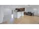 Bright, open-concept living space with modern kitchen, hardwood floors, and ample natural light, perfect for Gathering gatherings and entertaining at 3301 Tuckahoe Pl, Holiday, FL 34690