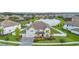 Aerial view of a home with manicured lawn, backyard lake, and surrounding community at 33075 Kateland Dr, Wesley Chapel, FL 33545