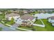 Stunning aerial view of a beautiful home, landscaped yard, and a tranquil community lake at 33075 Kateland Dr, Wesley Chapel, FL 33545
