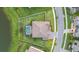 Aerial view of home with backyard pool, manicured lawn, and proximity to pond at 33075 Kateland Dr, Wesley Chapel, FL 33545