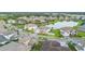 An aerial view of a residential community with a pond and well-maintained lawns at 33075 Kateland Dr, Wesley Chapel, FL 33545