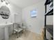 Bathroom with white fixtures, a sink, a toilet, and shelves at 33075 Kateland Dr, Wesley Chapel, FL 33545