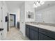 Bathroom featuring dual vanities, granite countertops and modern fixtures at 33075 Kateland Dr, Wesley Chapel, FL 33545