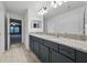 Bathroom featuring a double vanity with granite countertops and modern fixtures at 33075 Kateland Dr, Wesley Chapel, FL 33545