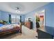 Cozy bedroom with blue walls, an exterior window, and a closet at 33075 Kateland Dr, Wesley Chapel, FL 33545