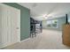 Bedroom features a bunkbed, carpet, a ceiling fan, and natural light from a large window at 33075 Kateland Dr, Wesley Chapel, FL 33545