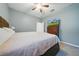 Inviting bedroom featuring carpet, light walls, TV, ceiling fan, and a cozy atmosphere at 33075 Kateland Dr, Wesley Chapel, FL 33545