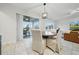 Bright dining area adjacent to the kitchen with sliding glass doors to the screened lanai at 33075 Kateland Dr, Wesley Chapel, FL 33545