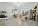 Bright home office with a chandelier, built in bookshelves, and natural light at 33075 Kateland Dr, Wesley Chapel, FL 33545