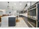 Open kitchen featuring a center island with a sink, stainless appliances, and gray cabinetry at 33075 Kateland Dr, Wesley Chapel, FL 33545