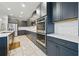 Well-equipped kitchen featuring gray cabinets, stainless appliances, and herringbone backsplash at 33075 Kateland Dr, Wesley Chapel, FL 33545