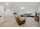 Spacious living room with carpet, recessed lighting, and multiple windows for natural light at 33075 Kateland Dr, Wesley Chapel, FL 33545