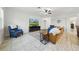 Bright living room featuring tile floors, ceiling fan, and comfortable seating arrangement at 33075 Kateland Dr, Wesley Chapel, FL 33545