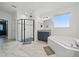 Bright main bathroom featuring a shower, soaking tub, and dual vanity sinks at 33075 Kateland Dr, Wesley Chapel, FL 33545