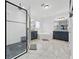 Bright bathroom with a glass enclosed shower, soaking tub and dual vanity sinks at 33075 Kateland Dr, Wesley Chapel, FL 33545