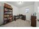Well-lit home office with a large bookcase and a cozy workspace, perfect for working from home at 33075 Kateland Dr, Wesley Chapel, FL 33545