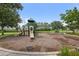 A vibrant playground with slides and swings amidst lush greenery in a residential community at 33075 Kateland Dr, Wesley Chapel, FL 33545
