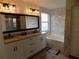 Updated bathroom featuring double sinks, granite countertops and a marble-walled soaking tub at 3512 Osprey Cove Dr, Riverview, FL 33578